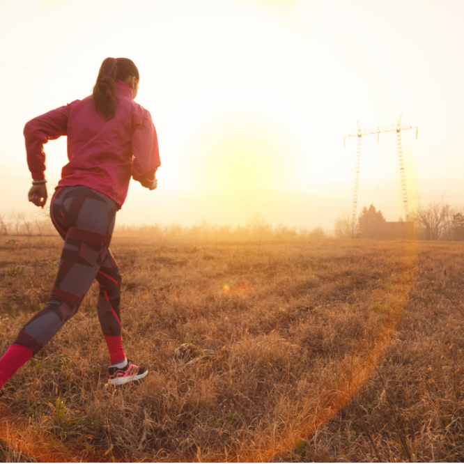 Lady is running towards the sunset
