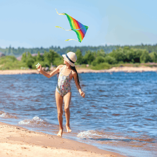 Girl flying a kite on a beach